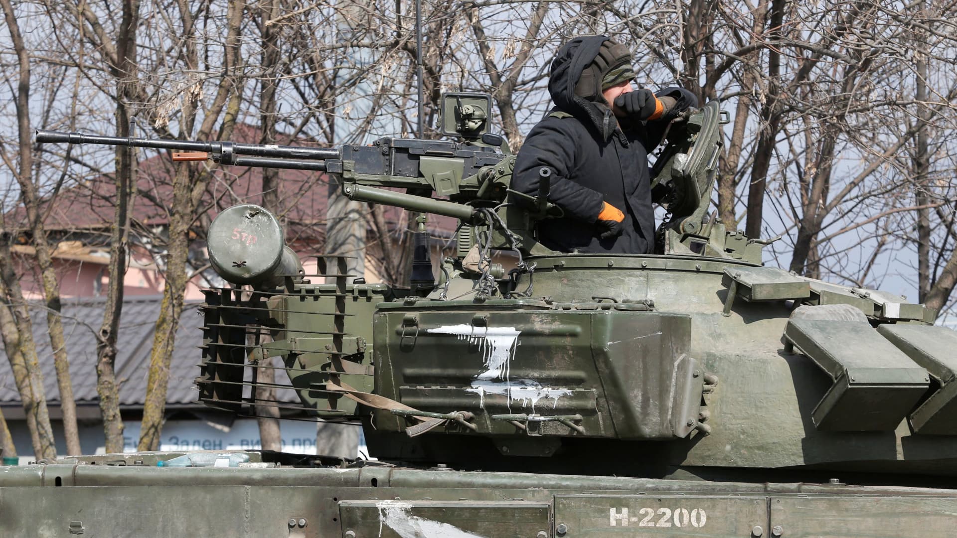 A service member of pro-Russian troops in uniform without insignia is seen atop of a tank during Ukraine-Russia conflict in the besieged southern port city of Mariupol, Ukraine March 18, 2022.