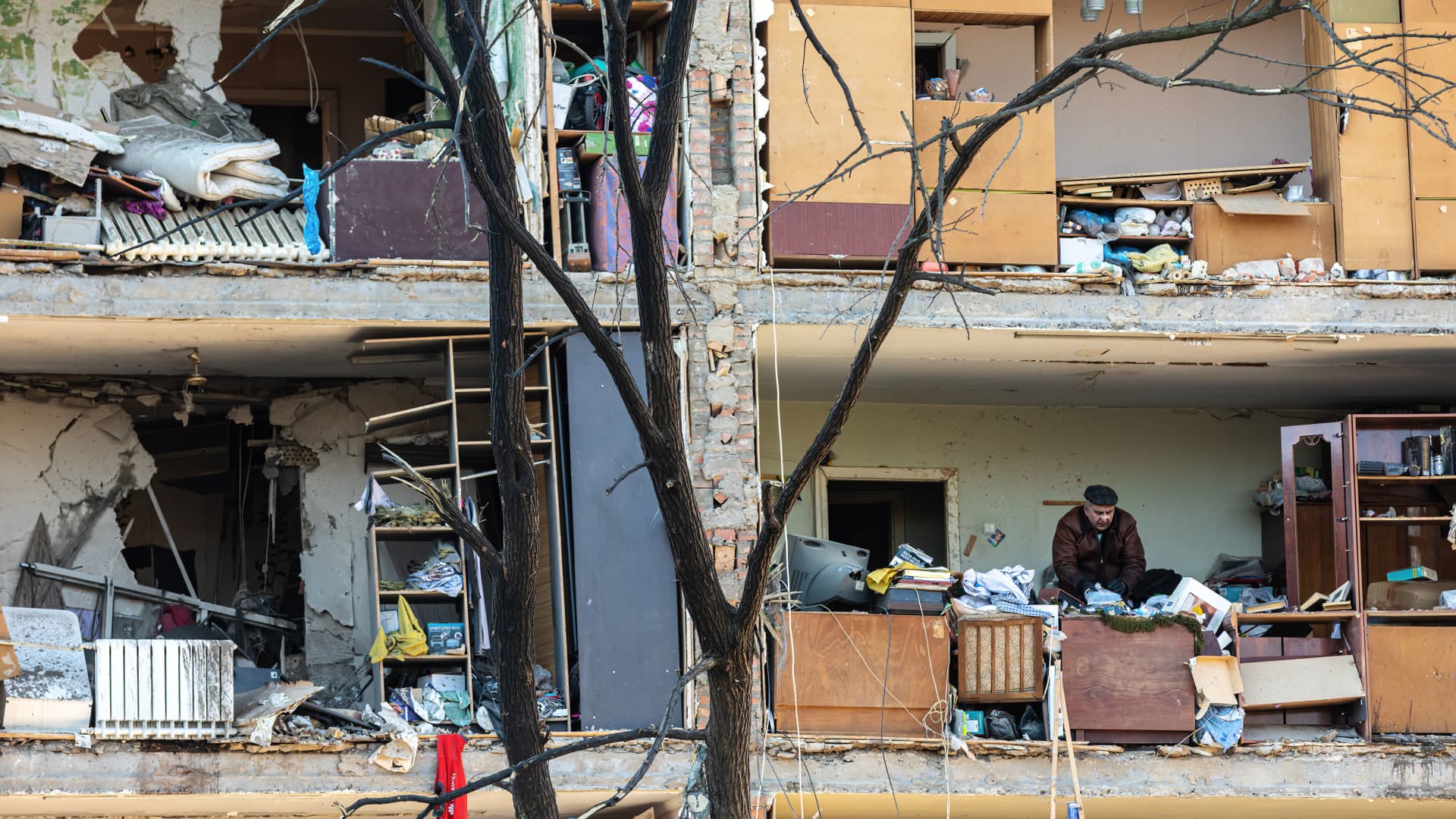 A resident seen collecting his belongings in a destroyed building.