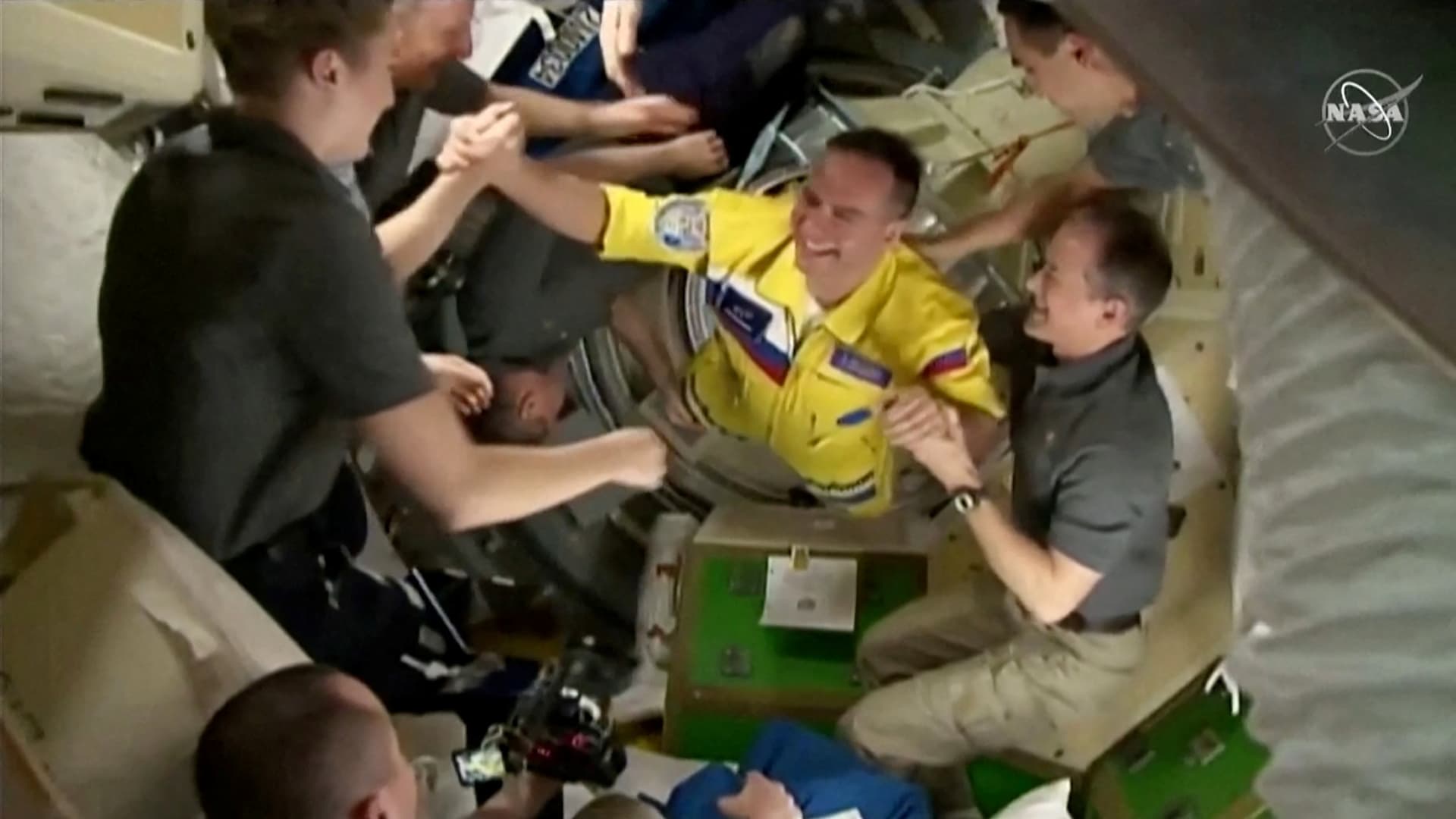 Russian cosmonauts arrive wearing yellow and blue flight suits at the International Space Station after docking their Soyuz capsule March 18, 2022 i a still image from video. Video taken March 18, 2022.
