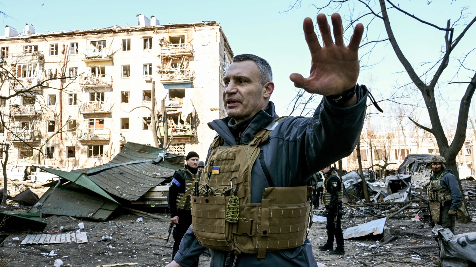 Kyiv's mayor Vitali Klitschko holds people away from a five-storey residential building that partially collapsed after a shelling in Kyiv on March 18, 2022, as Russian troops try to encircle the Ukrainian capital as part of their slow-moving offensive.