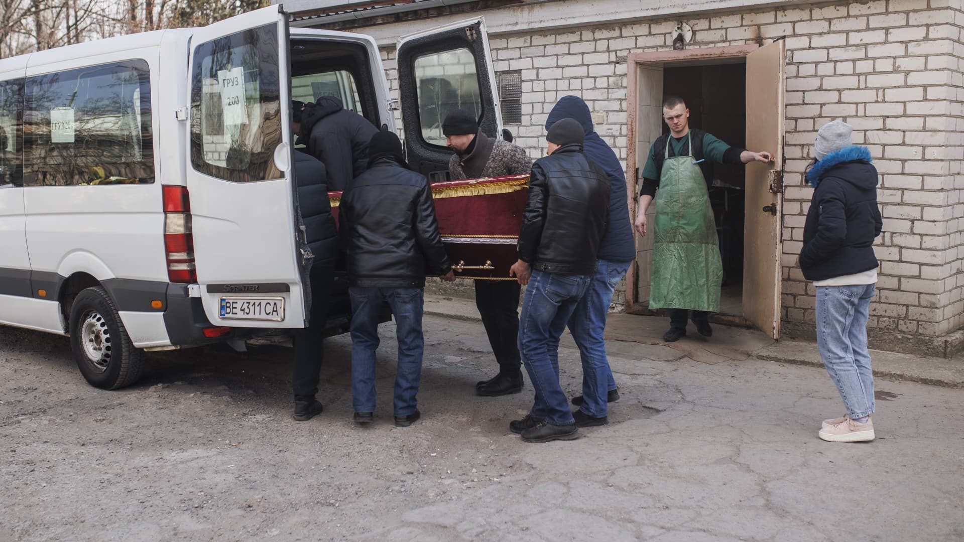 Workers load a coffin of a Ukrainian soldier onto a car at the morgue in Mykolaiv, Ukraine on March 18, 2022.