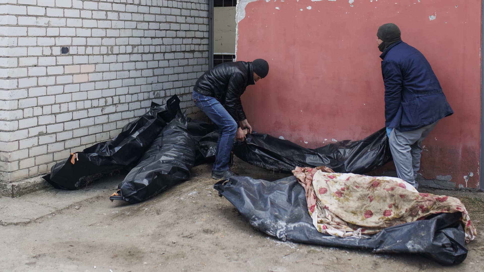 Workers transport a corpse of a Ukrainian soldier at the morgue in Mykolaiv, Ukraine on March 18, 2022.