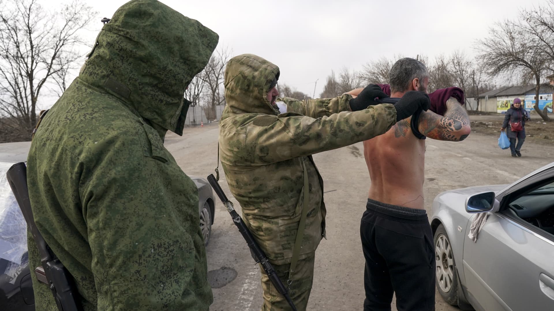A civilian is being controlled at a check point by pro-Russian separatists as civilians trapped in Mariupol city under Russian attacks, are evacuated in groups under the control of pro-Russian separatists, through other cities, in Mariupol, Ukraine on March 20, 2022.