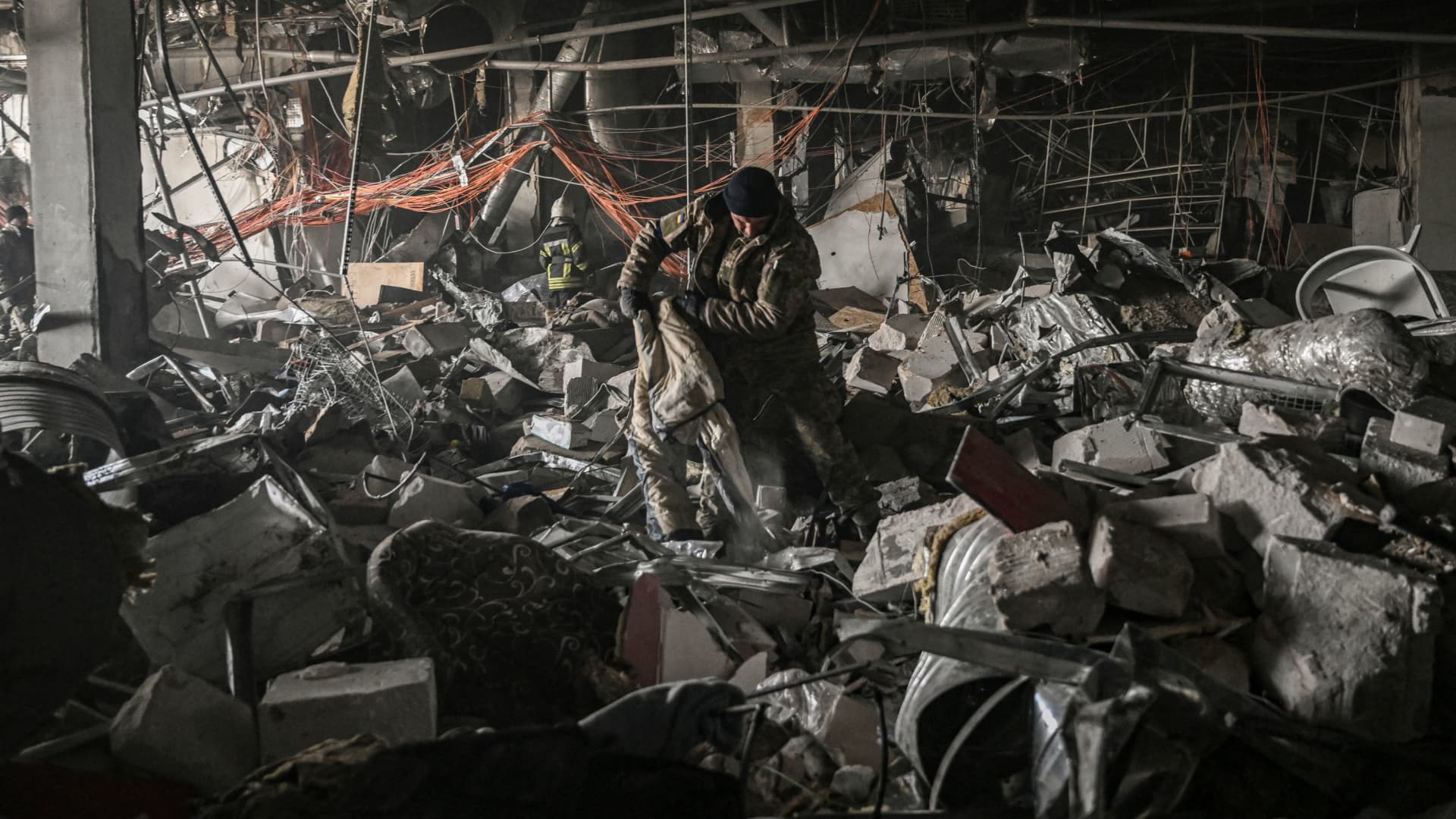 Ukranian servicemen search through rubble inside the Retroville shopping mall after a Russian attack in northwest of Kyiv on March 21, 2022.