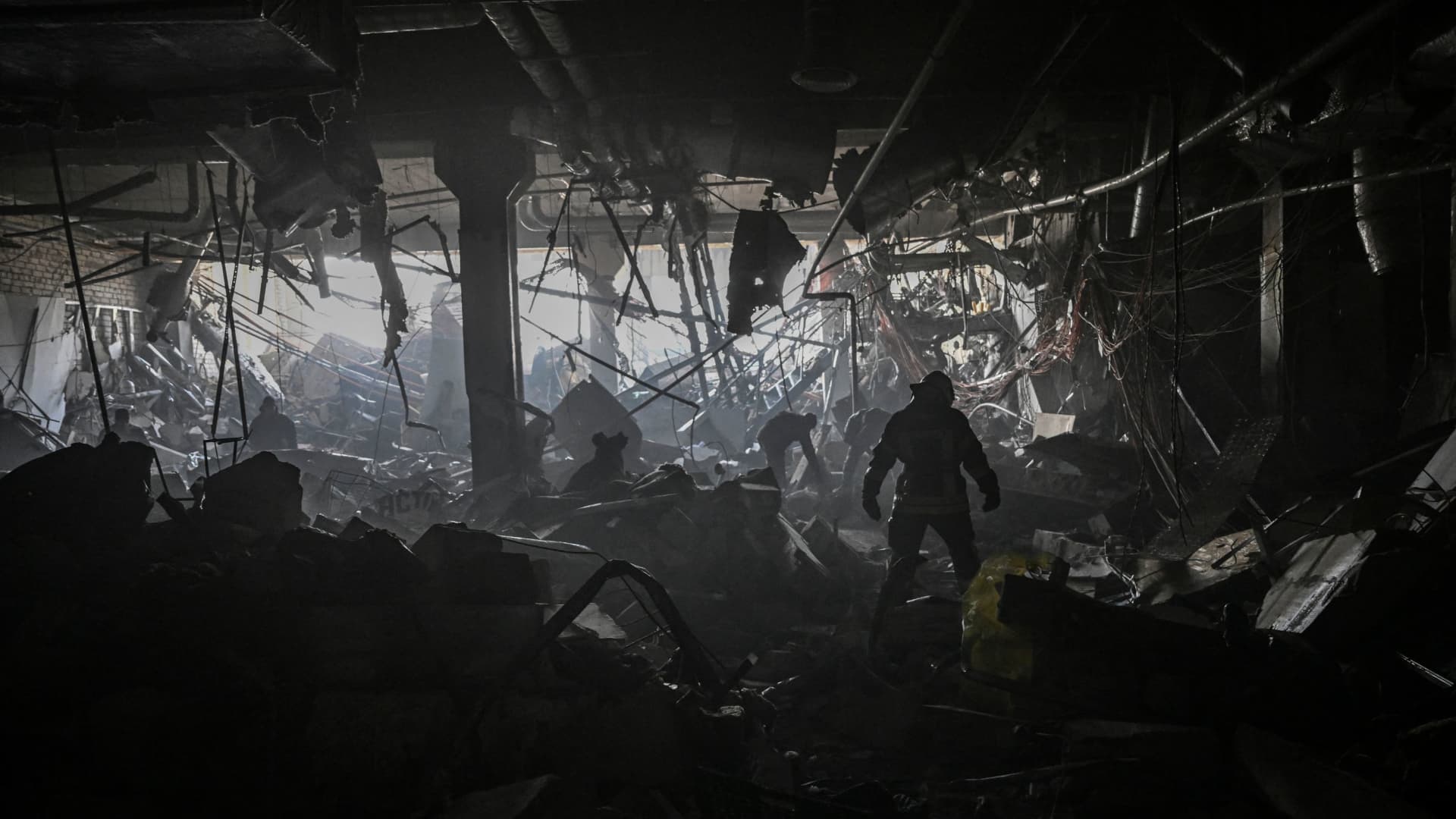 A Ukranian serviceman walks between debris inside the Retroville shopping mall after a Russian attack on the northwest of the capital Kyiv on March 21, 2022.