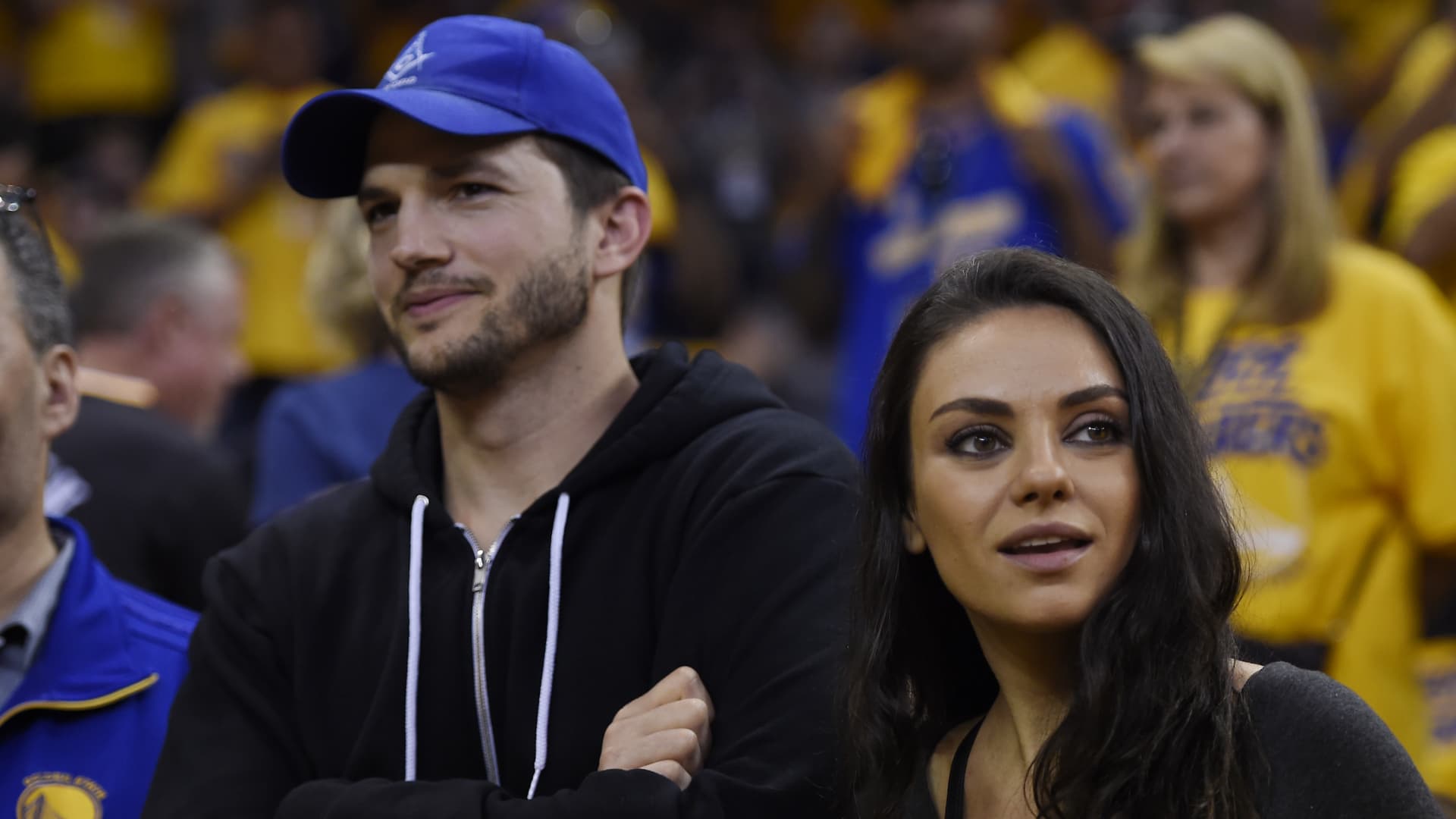 Mila Kunis stands with her husband Ashton Kutcher before Game 2 of the NBA Finals at Oracle Arena in Oakland, Calif., on Sunday, June 5, 2016.