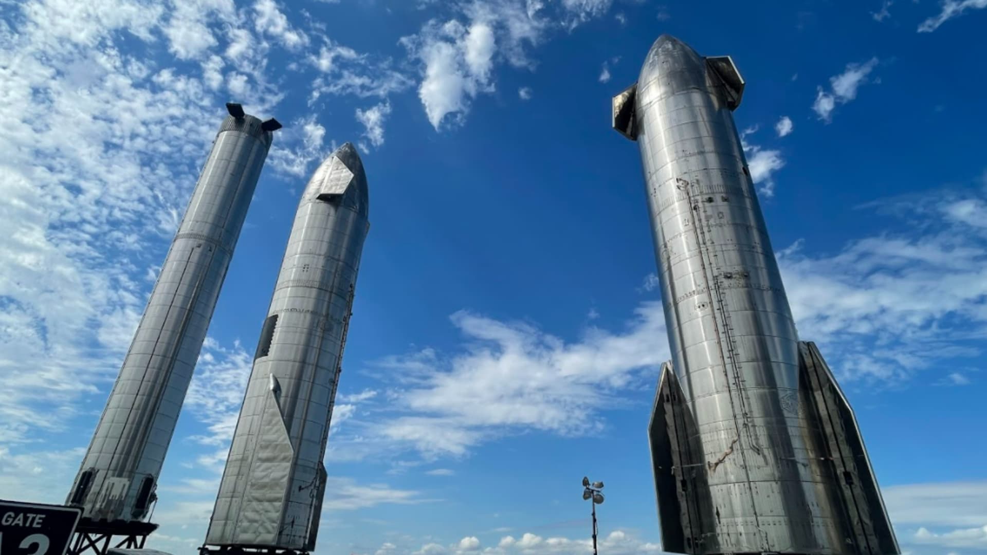 Prototypes of SpaceX's Starship rocket and Super Heavy booster stand at the company's Starbase facility in Texas.