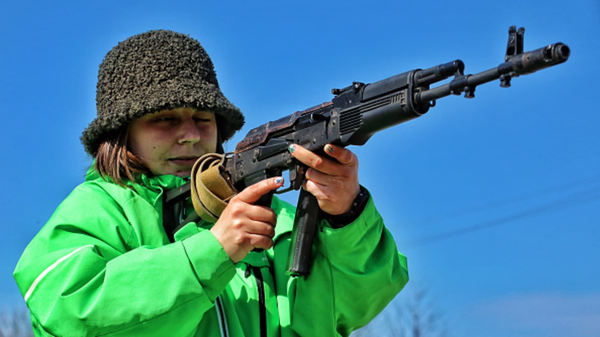 A participant of a civilian firearms training class takes aim at a target, Odessa, southern Ukraine