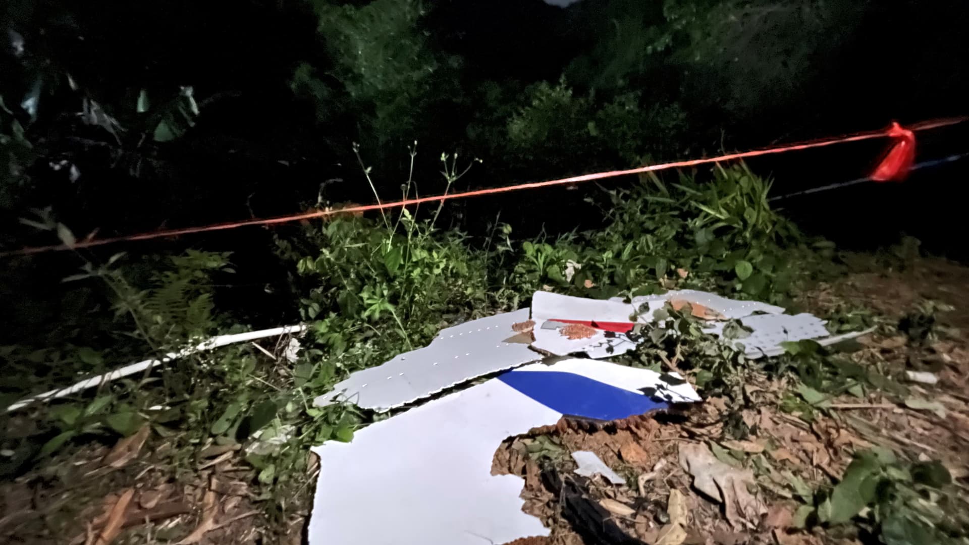 Photo taken with a mobile phone shows pieces of a crashed passenger plane's wreckage found at the crash site in Tengxian County, south China's Guangxi Zhuang Autonomous Region, March 22, 2022.
