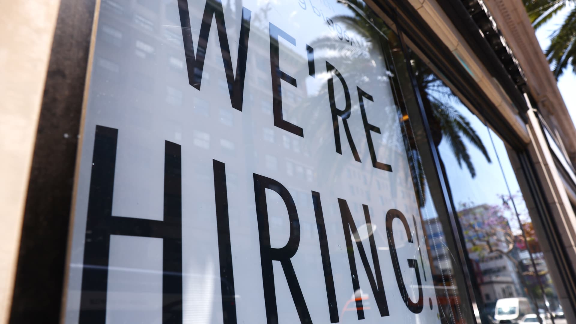 A 'We're Hiring!' sign is displayed at a Starbucks