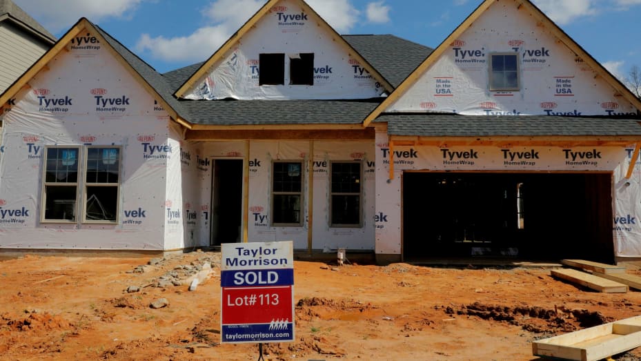 A home under construction stands behind a "sold" sign in a new development in York County, South Carolina.