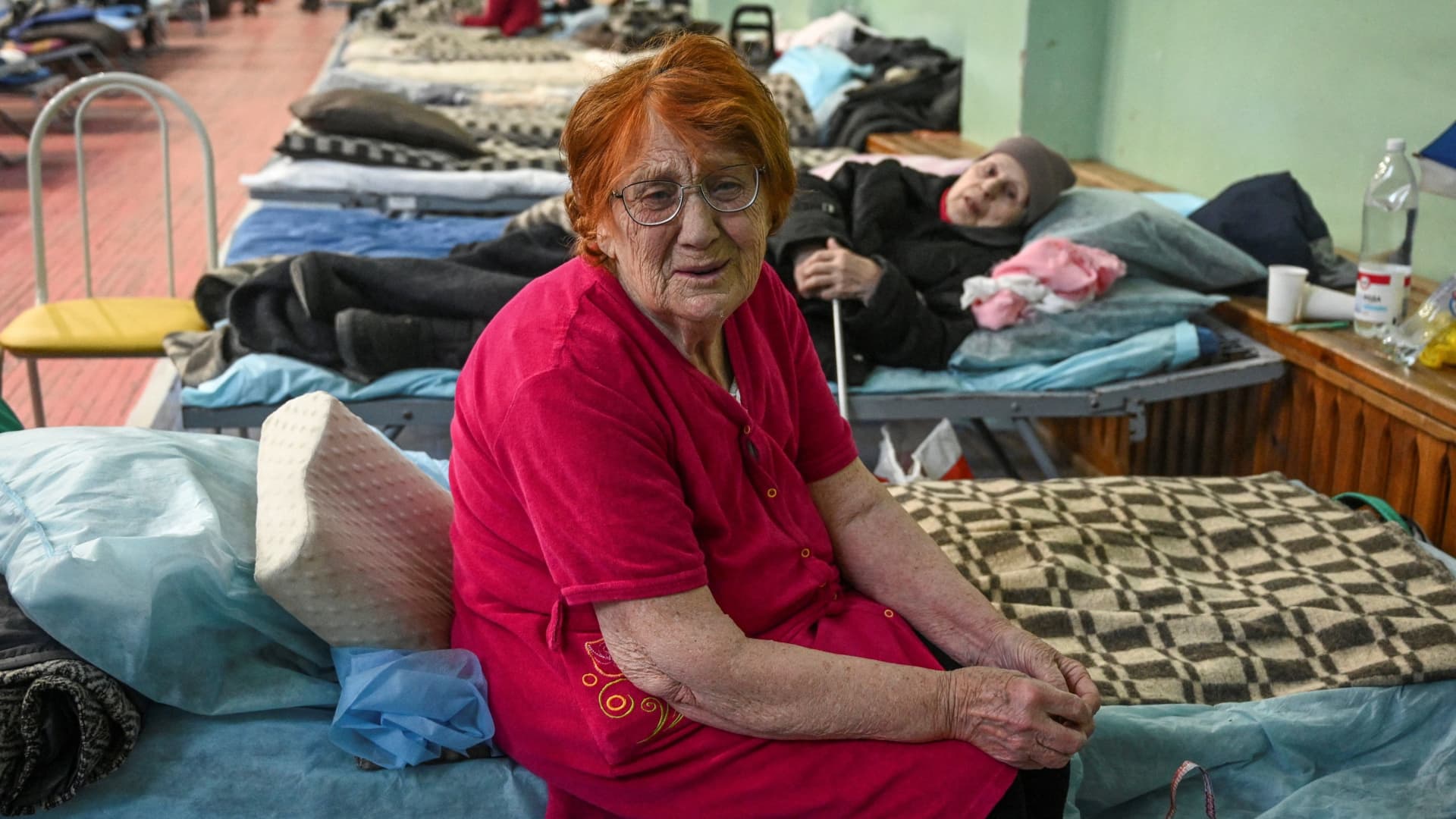 Raisa Kairat and Zinaida Bogdanova, residents of the Ukrainian city of Mariupol, react as they stay at a temporary accommodation centre for evacuees located in the building of a local sports school in Taganrog in the Rostov region, Russia March 23, 2022.