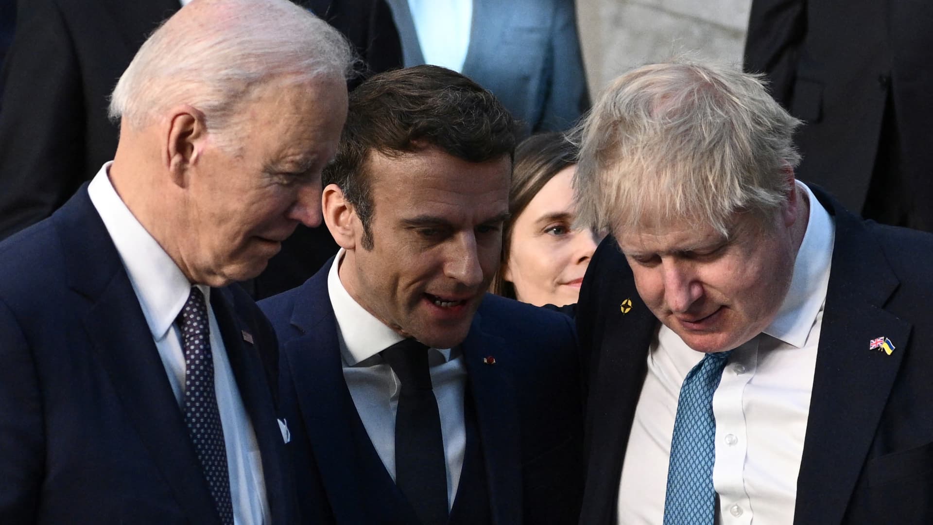 Britain's Prime Minister Boris Johnson, France's President Emmanuel Macron and US President Joe Biden talk as they arrive at NATO Headquarters in Brussels, Belgium, March 24, 2022.