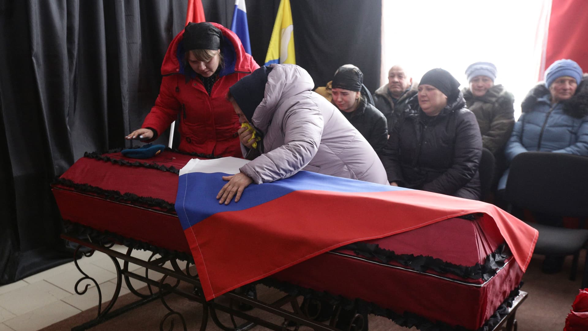 People attend a farewell ceremony for Sergei Sokolov, the 21 year-old serviceman who was killed during Russian military action in Ukraine, in the settlement of Zubkovo in Novosibirsk region on March 24, 2022.