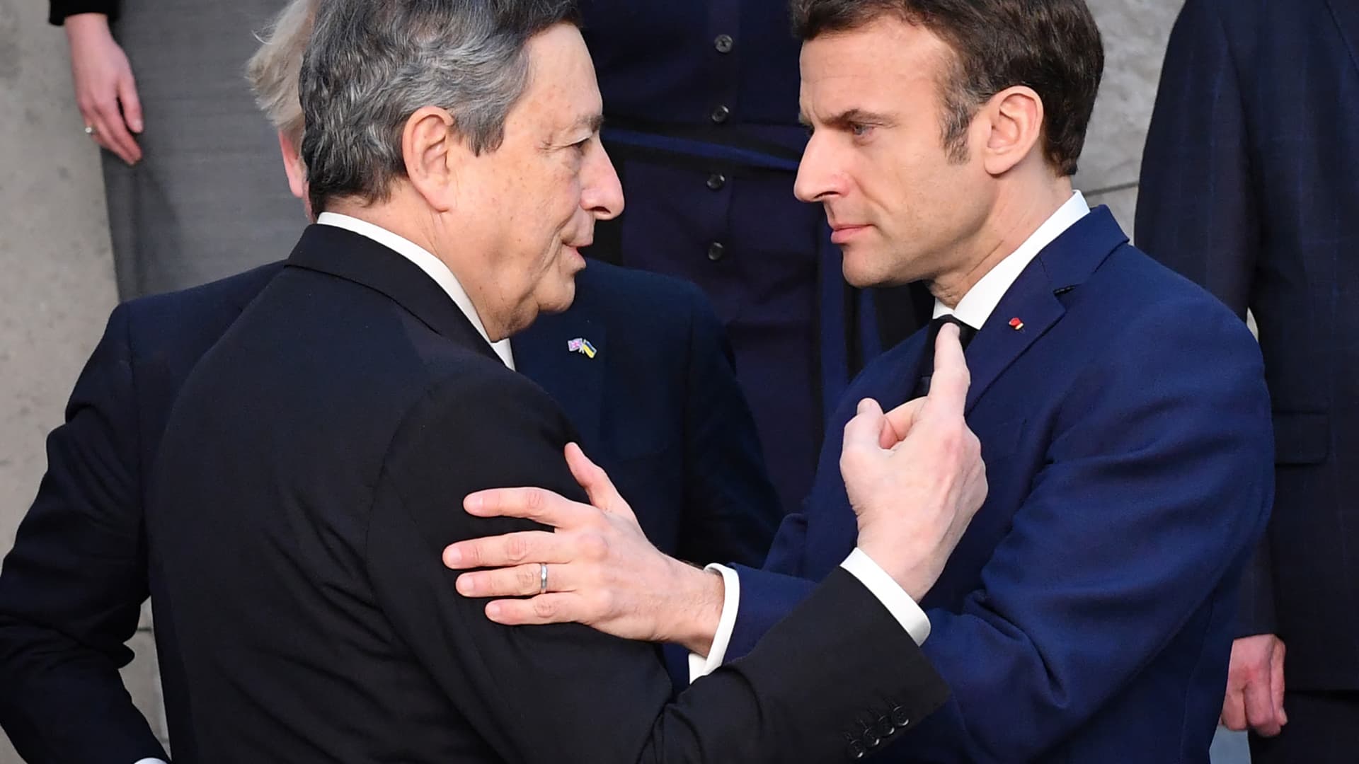 Italy's Prime Minister Mario Draghi shakes hands with France's President Emmanuel Macronat NATO Headquarters in Brussels on March 24, 2022.