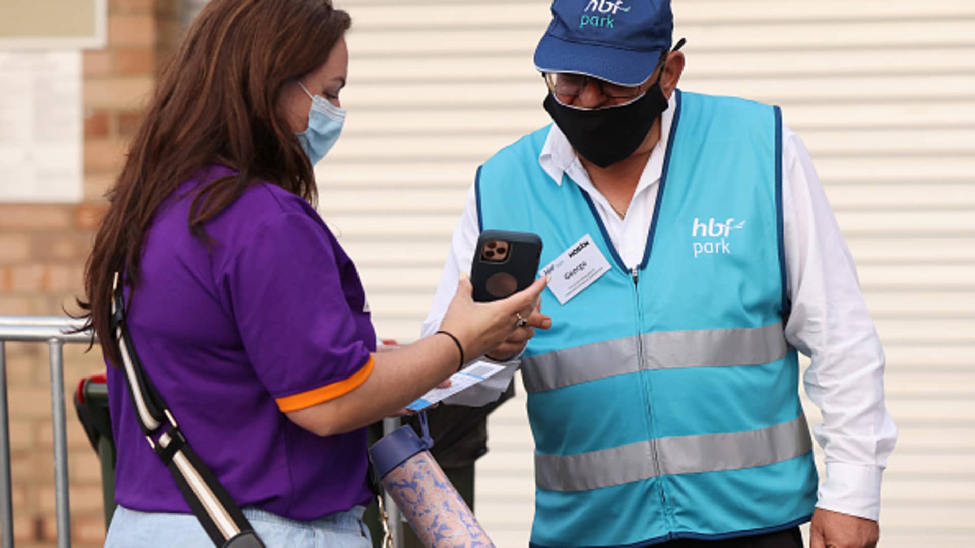 A masked spectator has her proof of vaccination verified before entering the A-League Men's match between Perth Glory and Central Coast Mariners at HBF Park on March 15, 2022, in Perth, Australia.