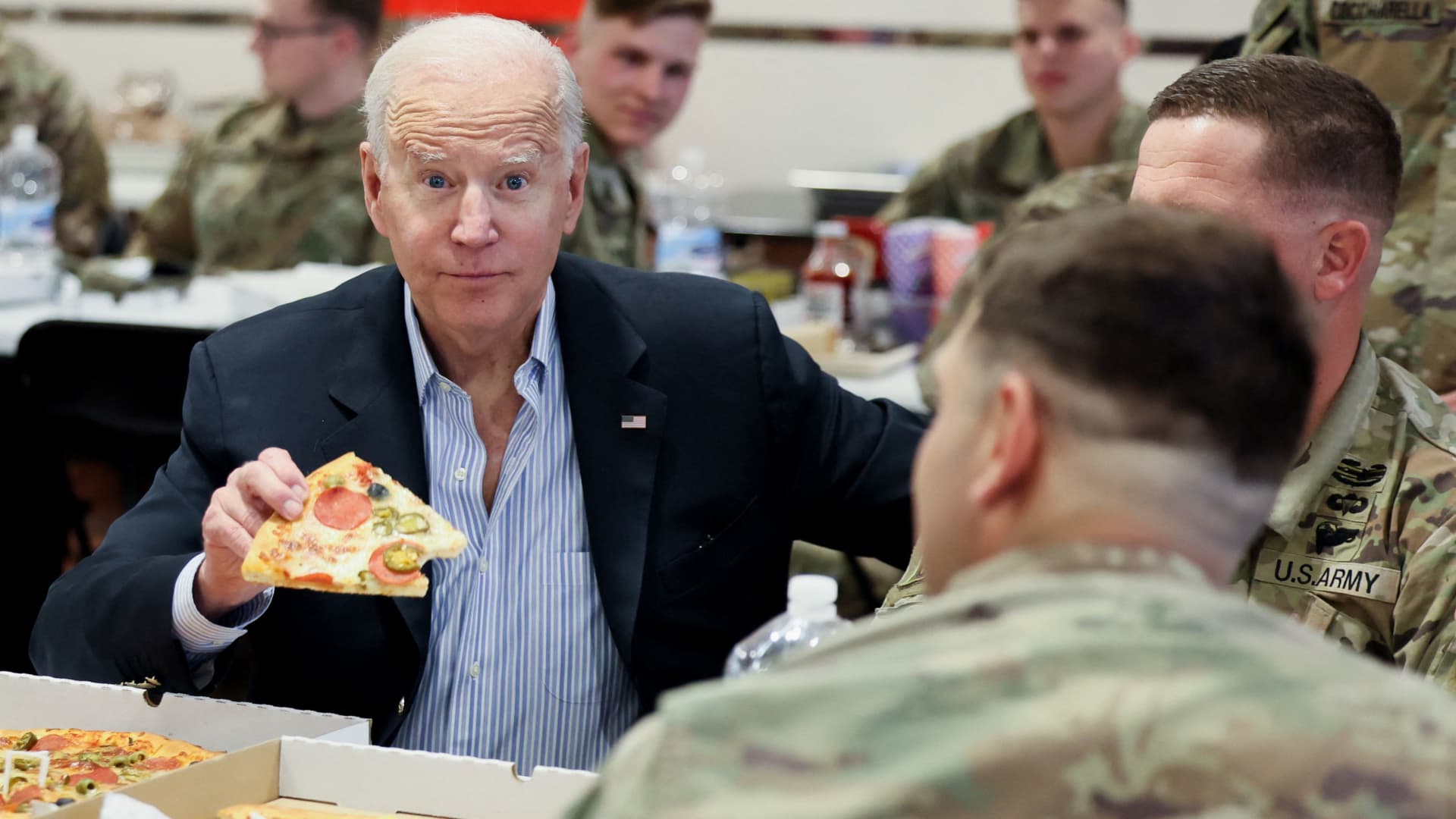 U.S. President Joe Biden eats pizza as he meets with U.S. Army soldiers assigned to the 82nd Airborne Division at the G2 Arena in Jasionka, near Rzeszow, Poland, March 25, 2022. 