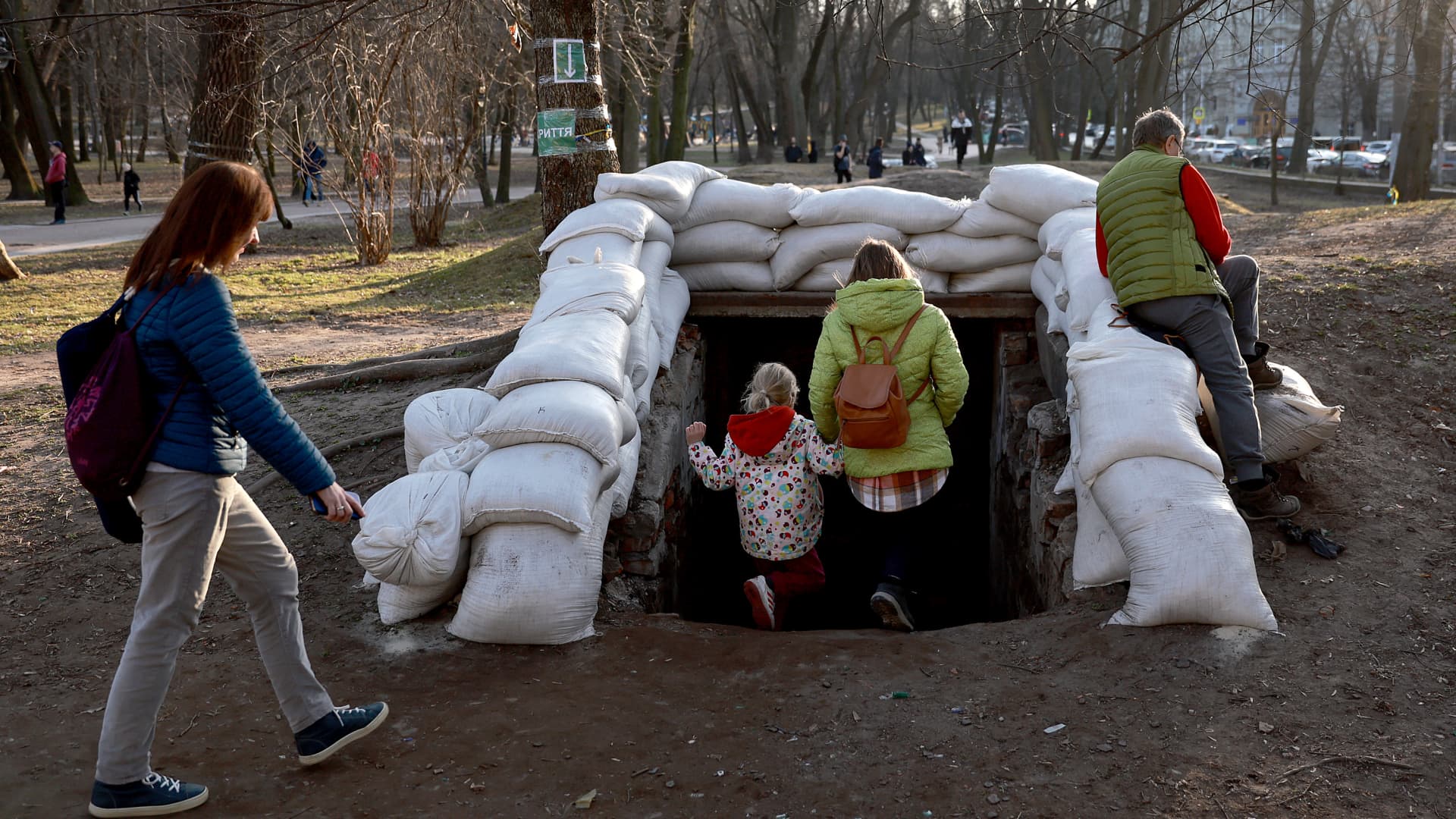 People walk down the sandbagged entrance to a bomb shelter after air raid sirens sounded on March 25, 2022 in Lviv, Ukraine.