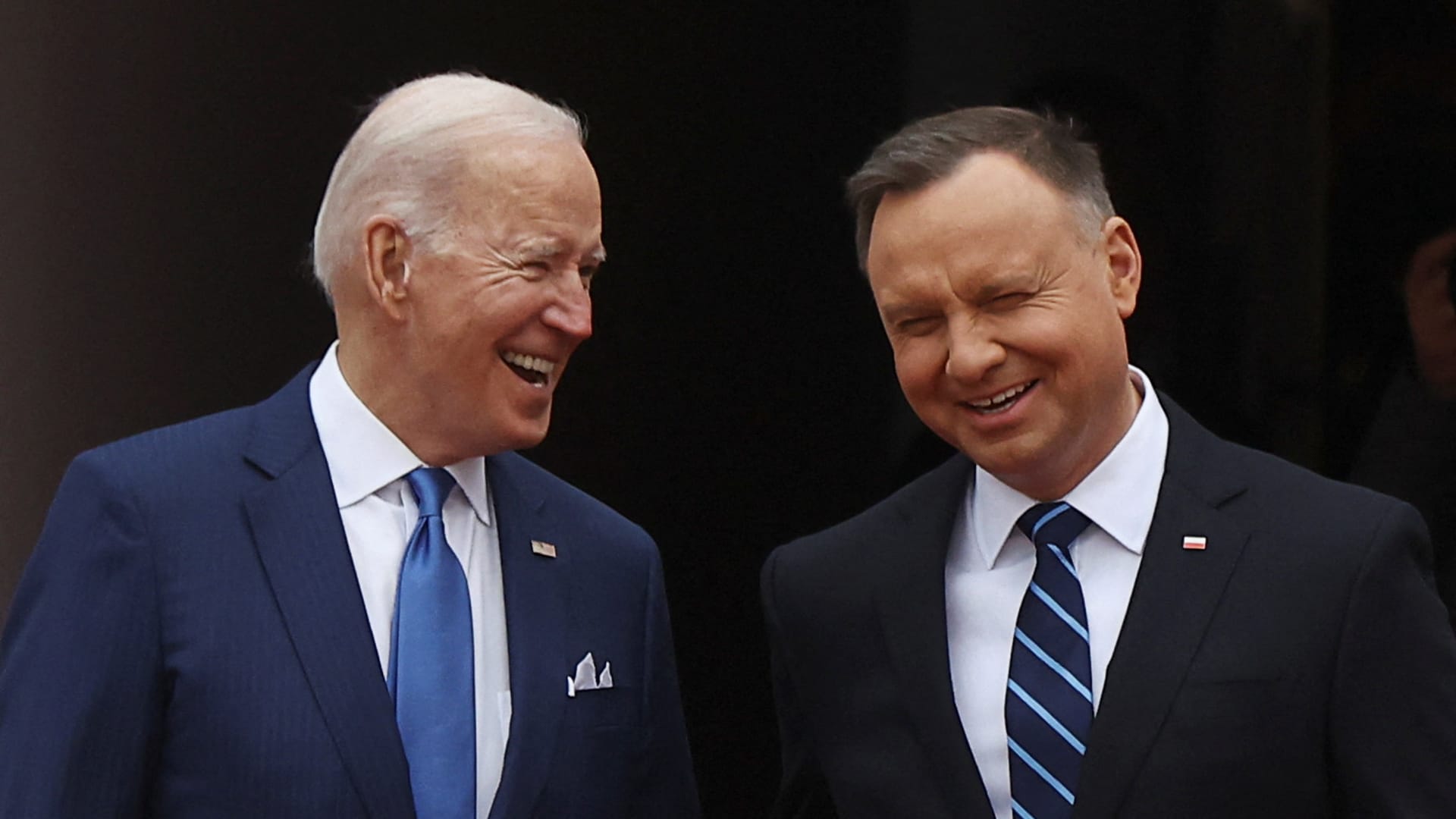 Polish President Andrzej Duda and the U.S. President Joe Biden interact, as the Russian invasion of Ukraine continues, outside the Presidential Palace in Warsaw, Poland March 26, 2022. 