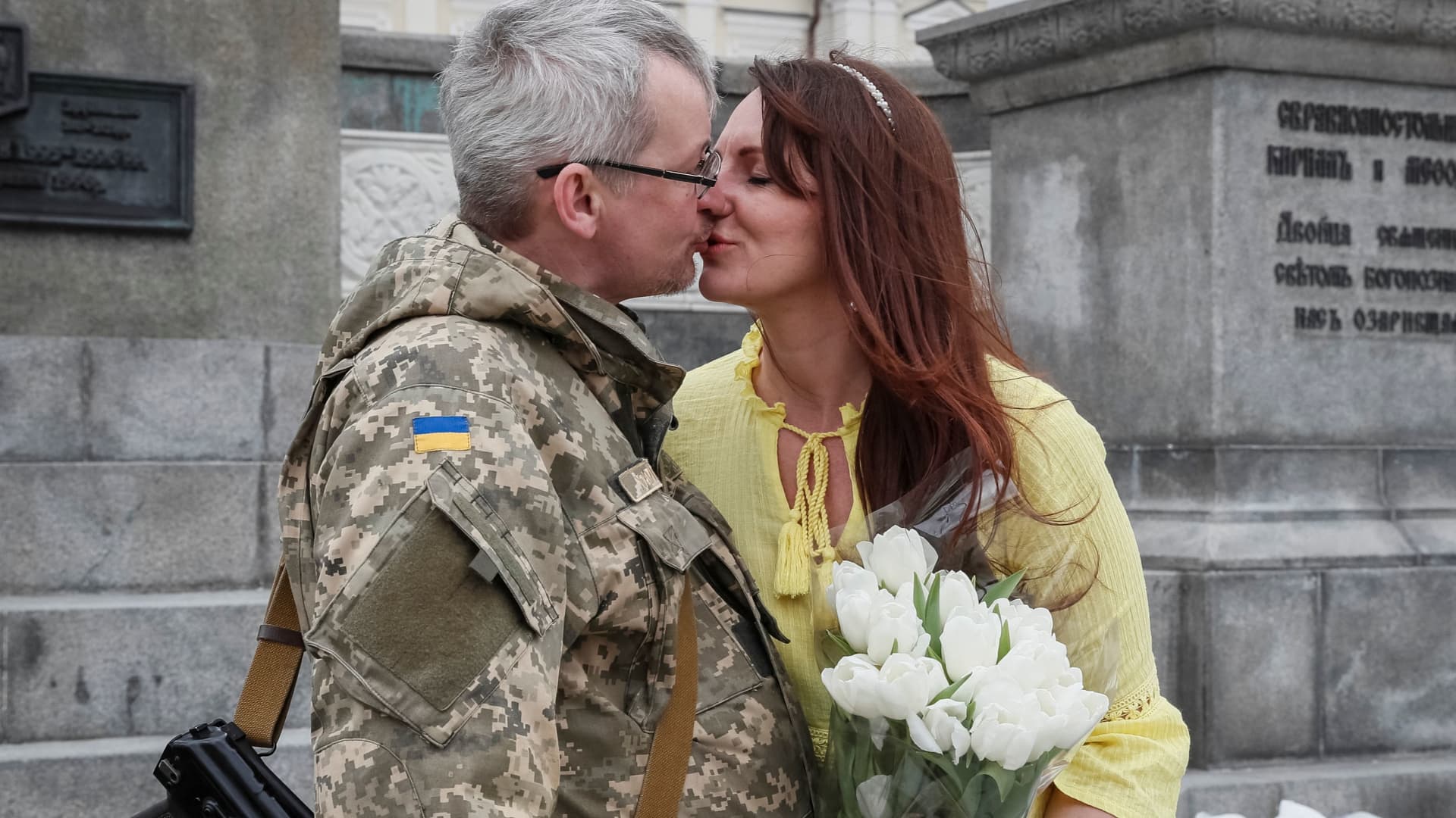 Newlywed Roman kisses his bride Ivanna in central Kyiv, Ukraine, March 26, 2022. 
