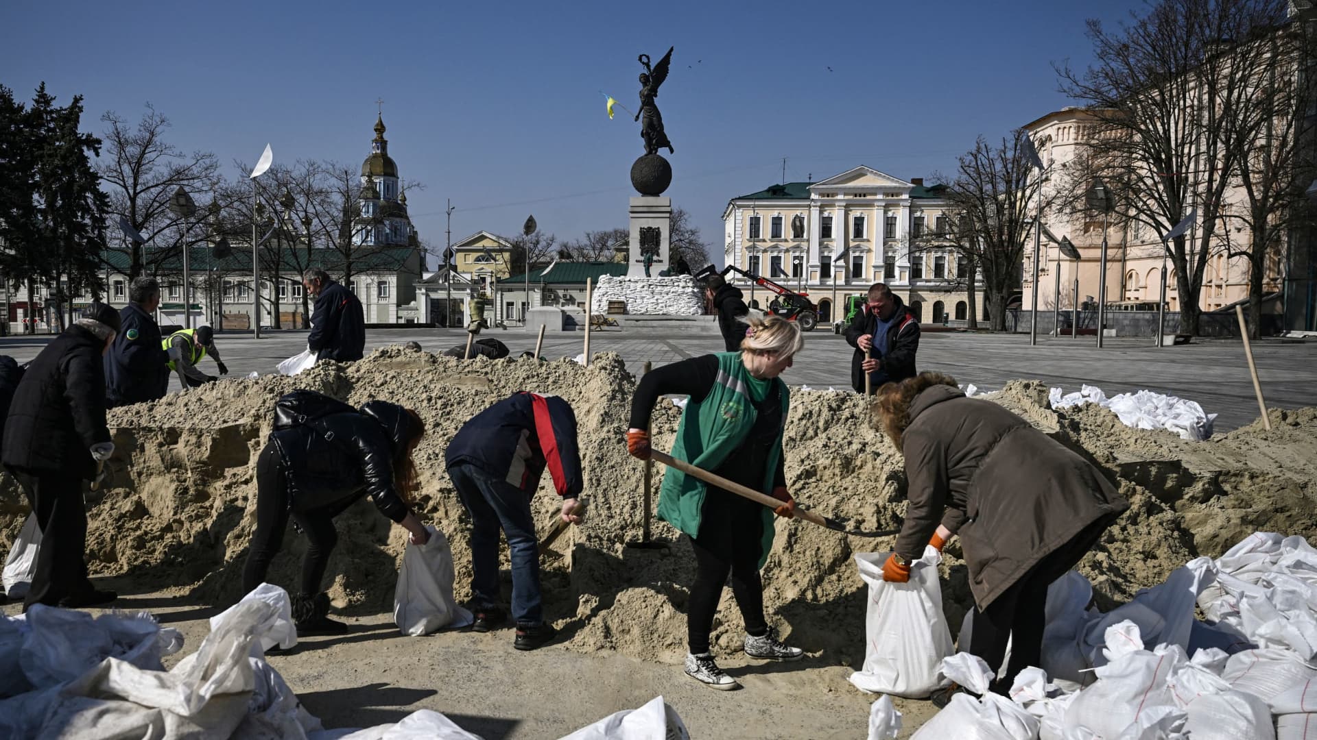 Kharkiv municipal employees fill bags with sand to protect the city's monuments from strikes on March 26, 2022 in Kharkiv where local authorities reported 44 Russian artillery bombardments and 140 rocket assaults in a single day.