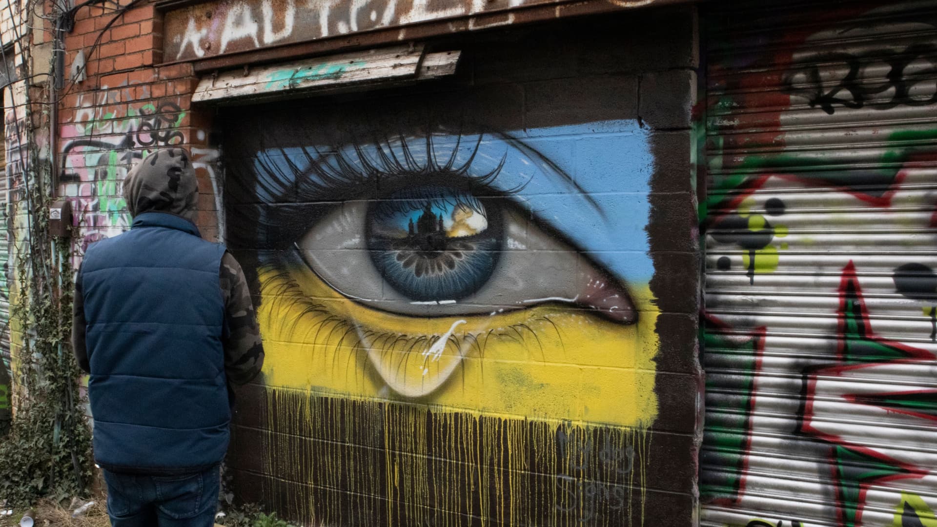 A resident looks at new street art mural has appeared in Cardiff depicting Ukraine's capital Kyiv under siege on March 01, 2022 in Cardiff, Wales.