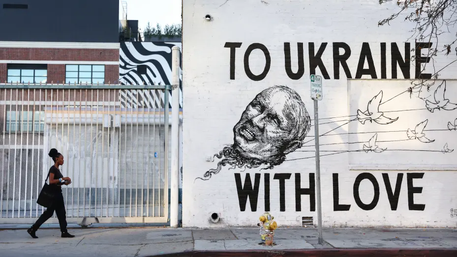 A person walks past the 'To Ukraine With Love' mural by artists Corie Mattie and Juliano Trindade depicting Russian President Vladimir Putin on March 14, 2022 in Los Angeles, California.