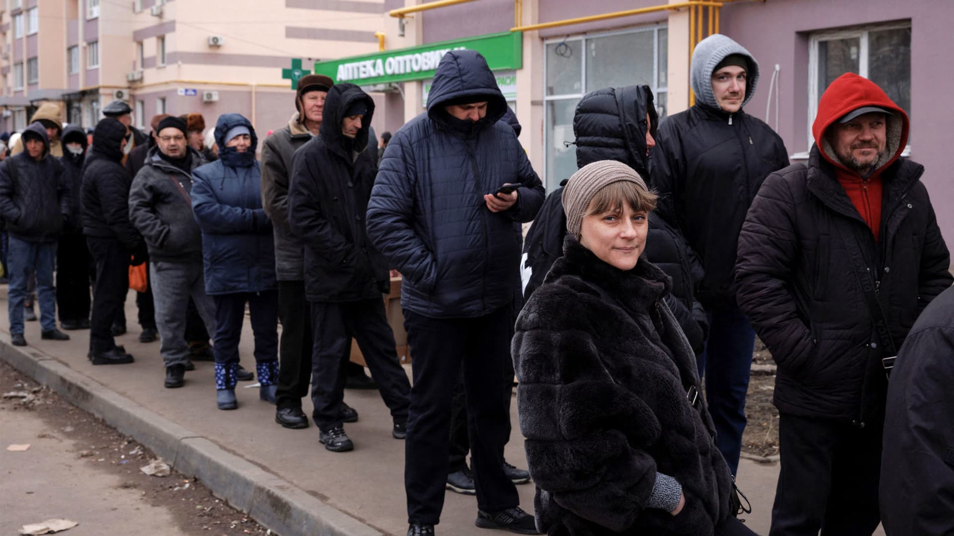 People line up for food handed out by volunteers at a humanitarian aid distribution point, as Russia's attack on Ukraine continues, in Kharkiv, Ukraine, March 28, 2022.