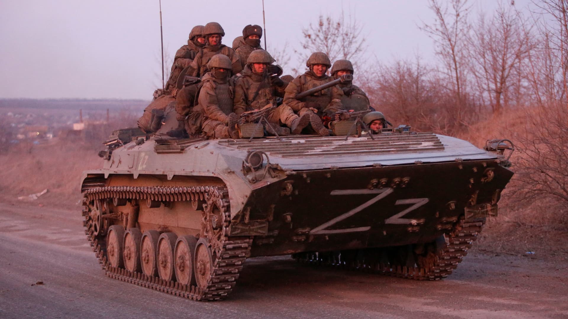 Service members of pro-Russian troops are seen atop of an armoured vehicle in the course of Ukraine-Russia conflict on a road leading to the besieged southern port city of Mariupol, Ukraine March 28, 2022.