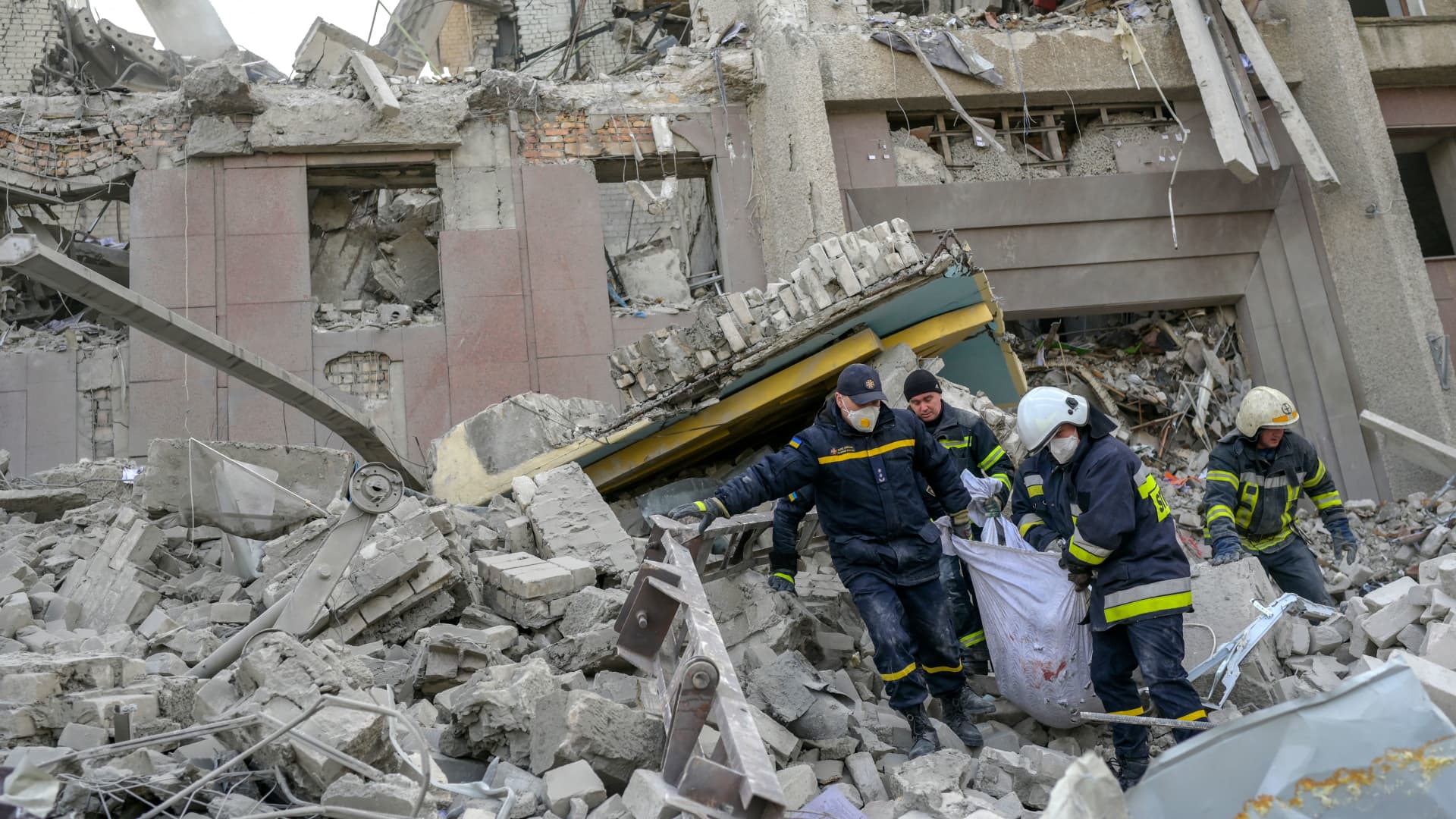 EDITORS NOTE: Graphic content: Firefighters carry a dead body from the rubble of a government building hit by Russian rockets in Mykolaiv on March 29, 2022.