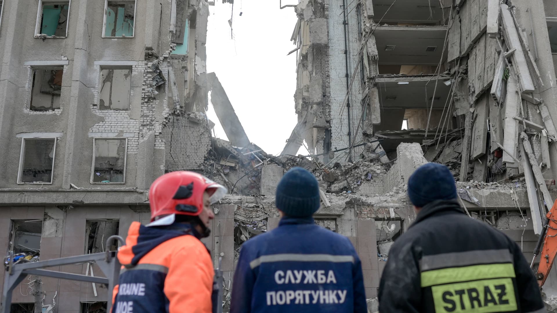 Rescue workers look at the rubble of government building hit by Russian rockets in Mykolaiv on March 29, 2022.