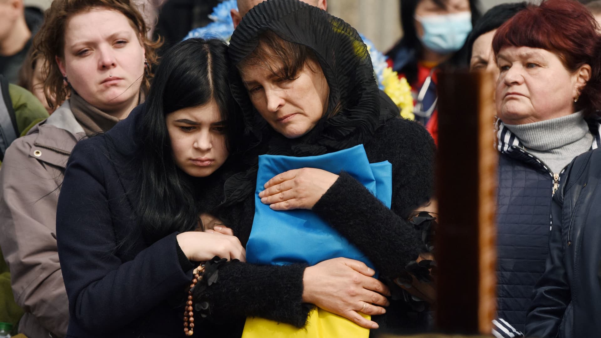 Relatives attend a ceremony at the funeral of the soldier Teodor Osadchyi, killed during the Russian invasion, at Lychakiv cemetery in Lviv, western Ukraine, on March 29, 2022.
