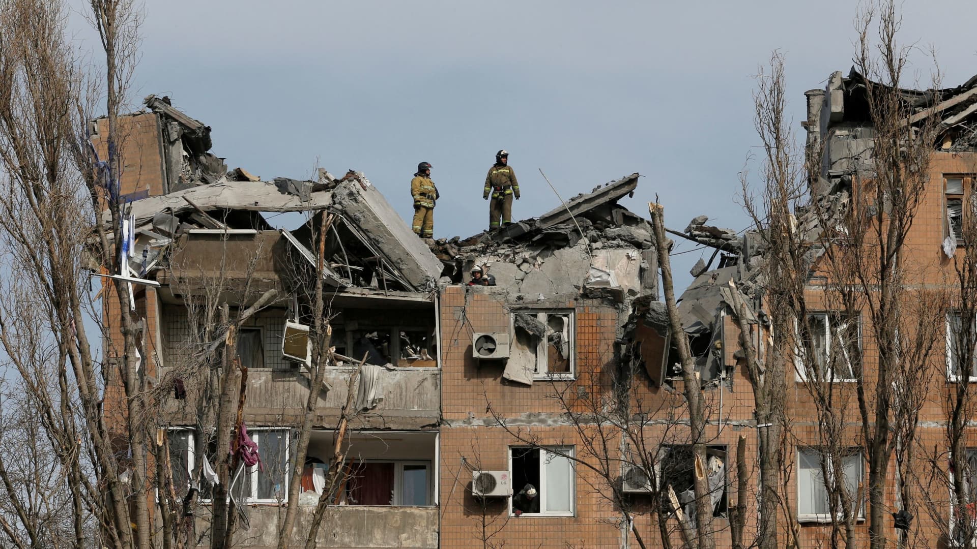 Emergency specialists work at a residential building damaged by shelling during Ukraine-Russia conflict in the separatist-controlled city of Donetsk, Ukraine, on March 30, 2022.