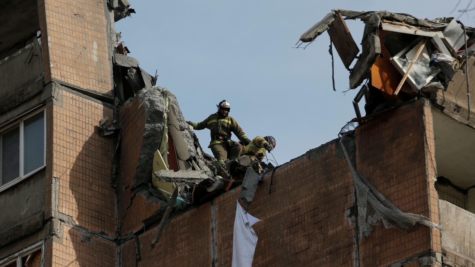 Firefighters work at a residential building damaged by shelling during Ukraine-Russia conflict in the separatist-controlled city of Donetsk, Ukraine March 30, 2022.