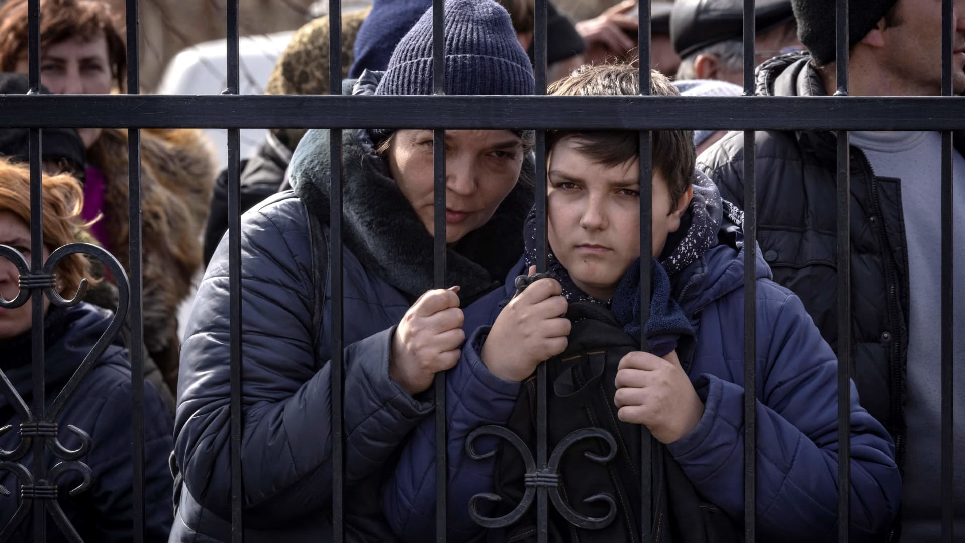 Residents wait for food outside a church in the northeastern city of Trostianets, on March 29, 2022.