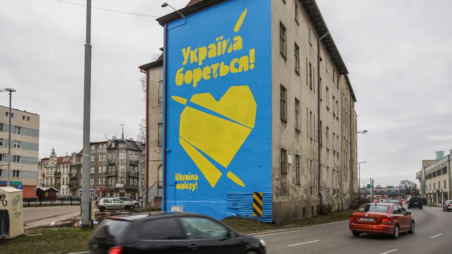 Yellow heart pierced by bullets on a blue background with inscription in Ukrainian and Polish - "Ukraine is fighting" - is seen in Gdansk, Poland on 6 March 2022 The mural was created to support Ukrainian people during the Russian war against Ukraine.