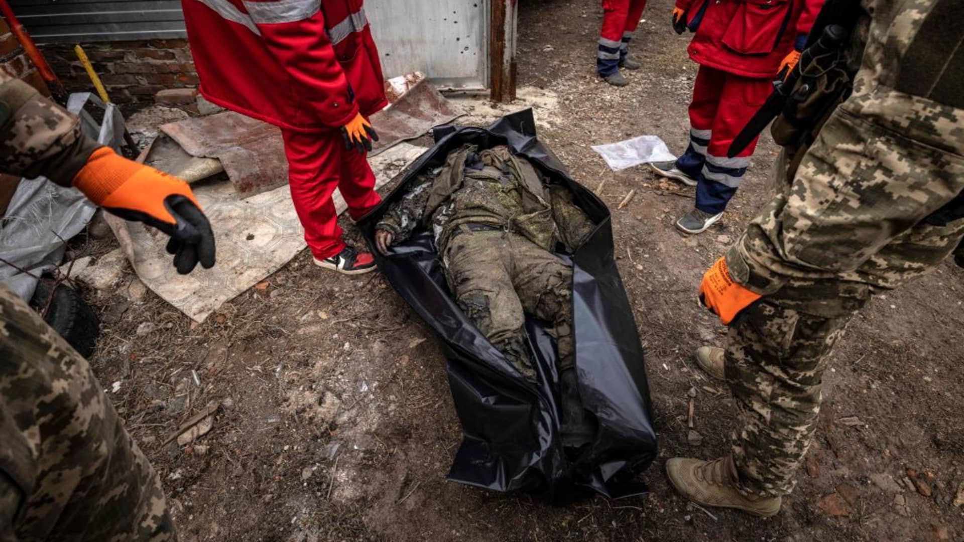 EDITORS NOTE: Graphic content / Ukrainian medics carry the body of a Russian soldier after the Ukranian troops retook the village of Mala Rogan, east of Kharkiv, on March 30, 2022.