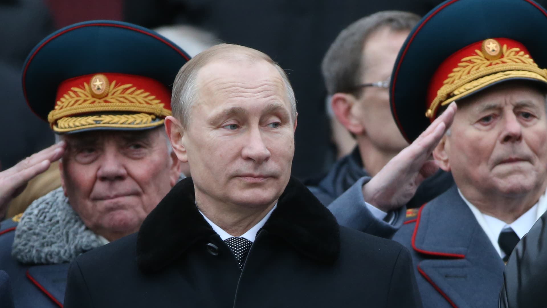 Russian President Vladimir Putin marks the Defender of the Fatheland Day in 2015 in central Moscow, Russia, with military officials surrounding him.