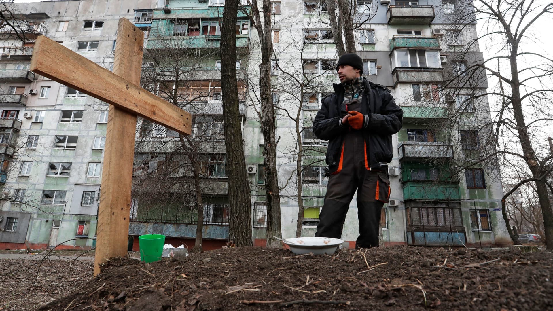 Local resident Pavel, 42, stands next to the grave of his friend Igor, who was killed by shelling while they were riding together in a car during Ukraine-Russia conflict, in a residential area in the besieged southern port city of Mariupol, Ukraine March 30, 2022.