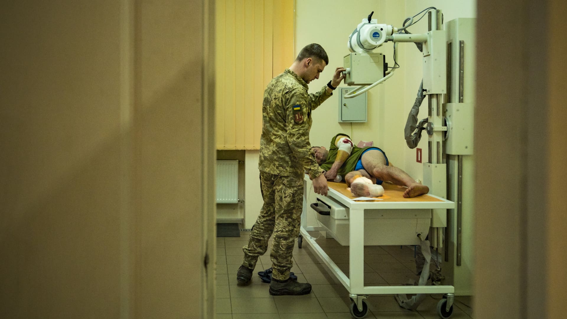 Military doctor prepares a wounded ukrainian soldier in the frontline of Zaporizhzhia for a radiography in a hospital. 