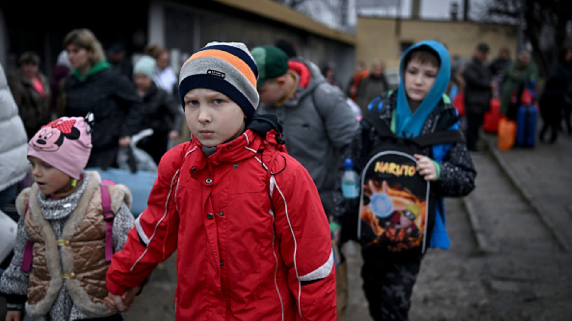 People, mainly women and children, make their way through Przemysl railway station after journeying from war-torn Ukraine on March 31, 2022 in Przemysl, Poland.