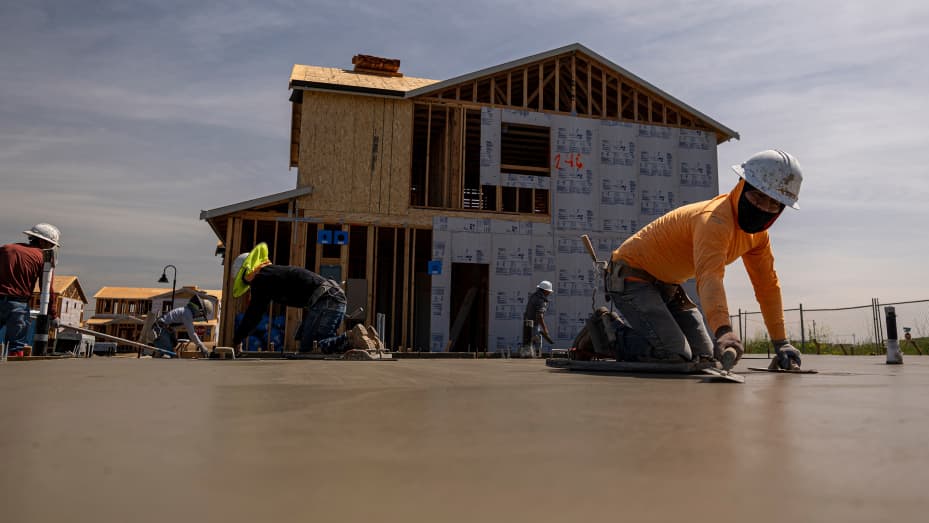 Contractors work on concrete slabs in the Cielo at Sand Creek by Century Communities housing development in Antioch, California, U.S., on Thursday, March 31, 2022.