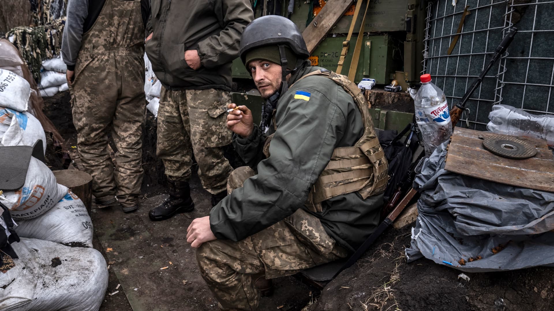 A Ukrainian serviceman smokes a cigaret in a trench at the front line east of Kharkiv on March 31, 2022.