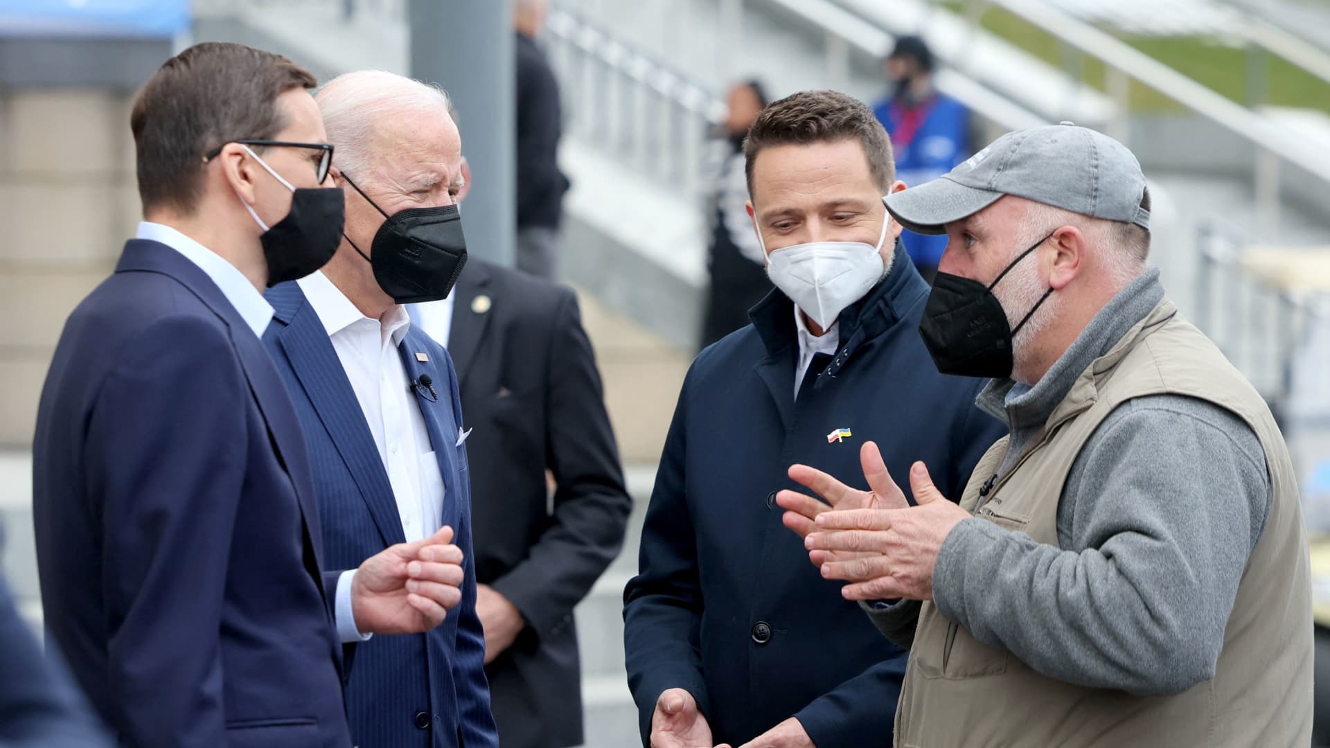 U.S. President Joe Biden, flanked by Mayor of Warsaw Rafal Trzaskowski and Polish Prime Minister Mateusz Morawiecki, speaks with chef Jose Andres from World Central Kitchen as he visits Ukrainian refugees at the PGE National Stadium, in Warsaw, Poland March 26, 2022. 