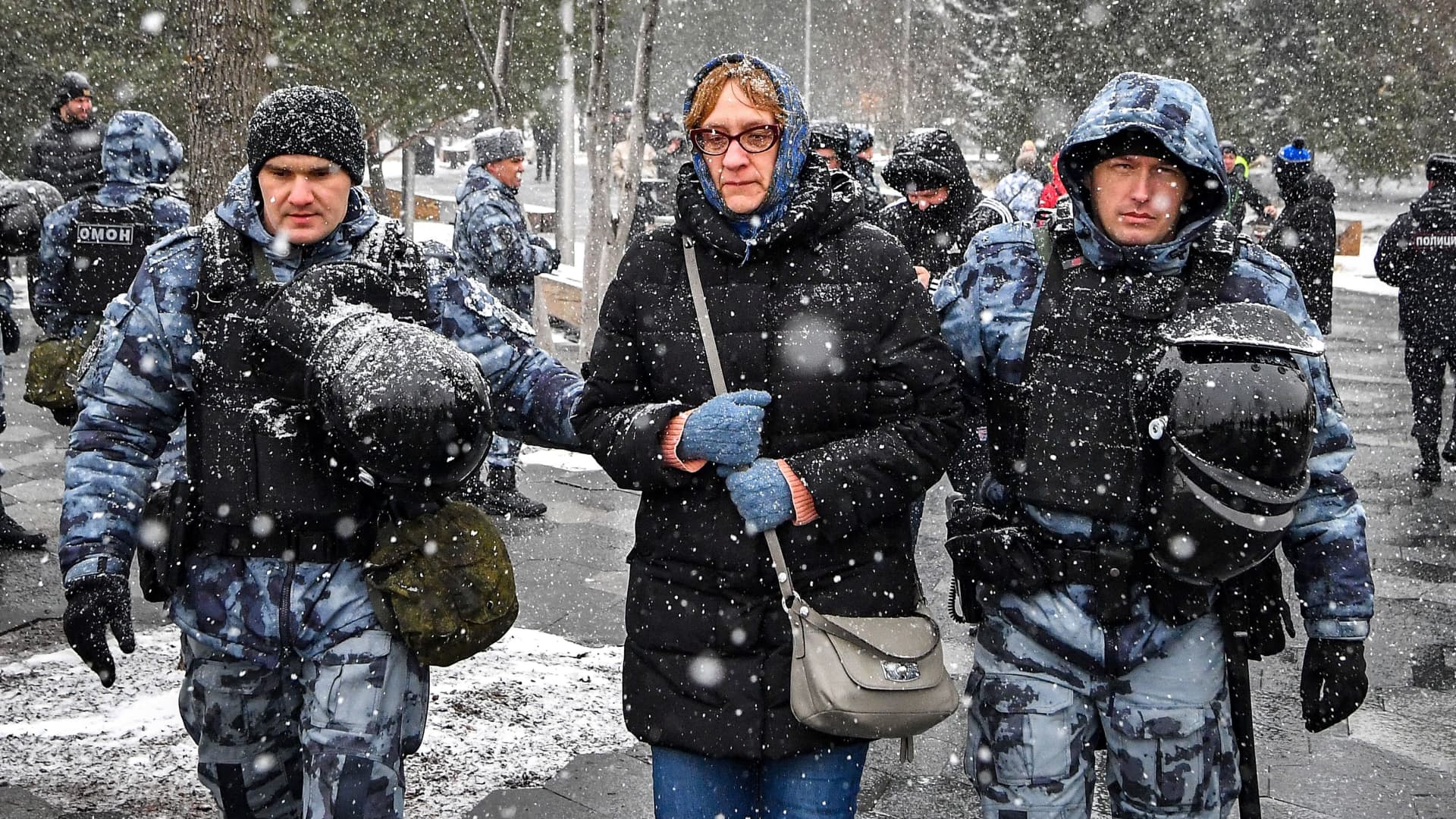 Police officers detain a woman during a protest against Russian military action in Ukraine, in central Moscow on April 2, 2022.