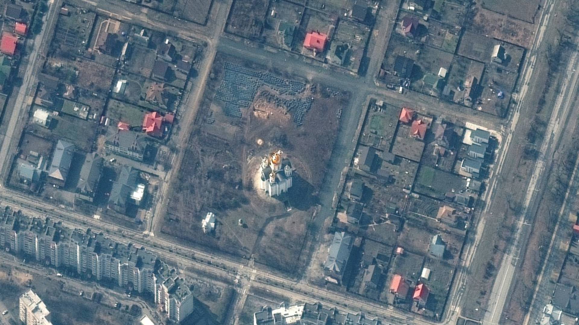 A satellite image shows the grave site with an approximately 45-foot (approximately 13,7 meters) long trench in the southwestern section of the area near the Church of St. Andrew and Pyervozvannoho All Saints, in Bucha, Ukraine, March 31, 2022. Picture taken March 31, 2022. Satellite image 2022 Maxar Technologies
