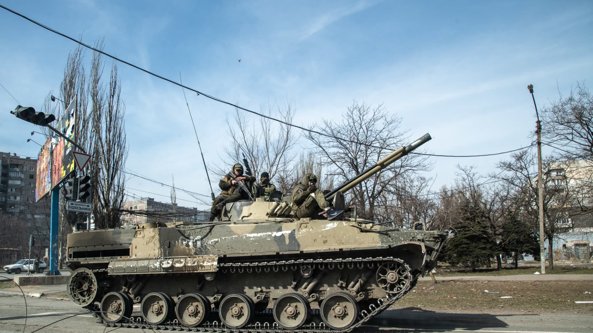 Russian troops atop a fighting vehicle ride through the streets of Mariupol on March 29.