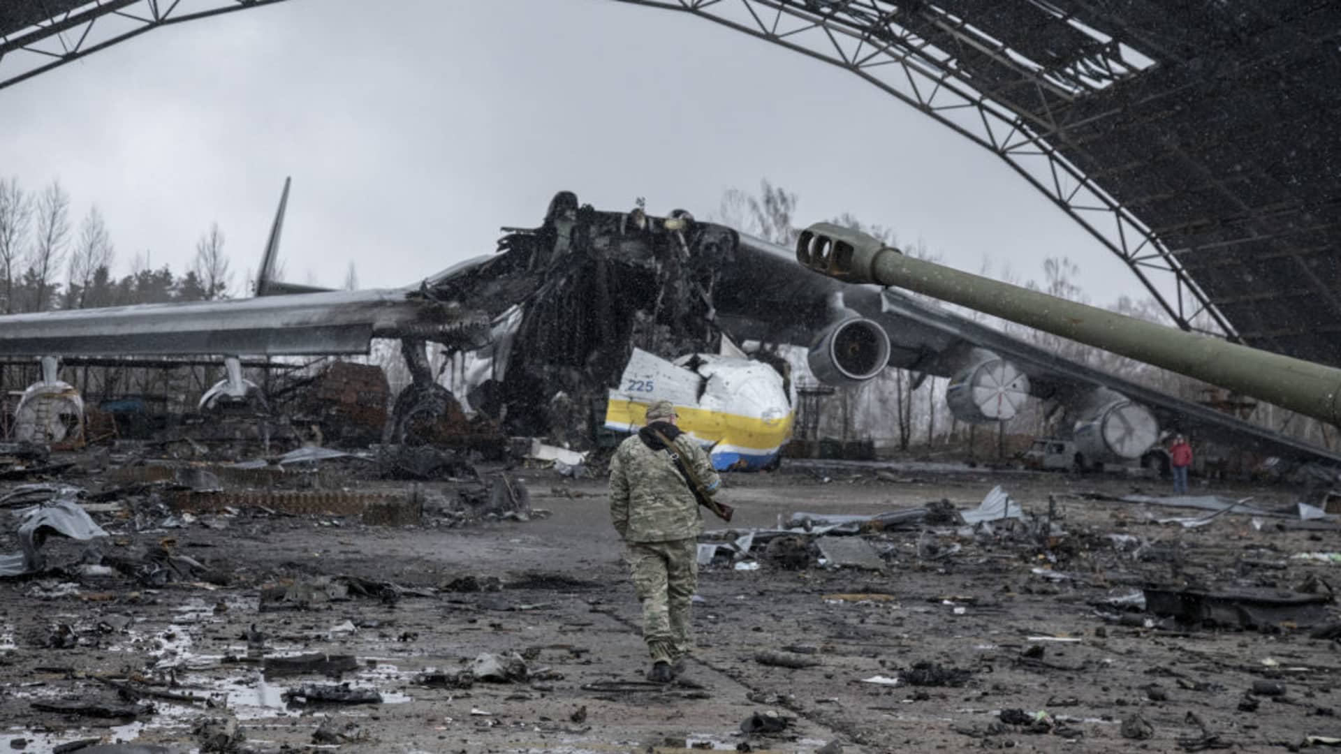 A Ukrainian serviceman walks by the wreckage of a cargo aircraft at the military airport in the town of Hostomel, on the outskirts of Kyiv, on April 3, 2022.