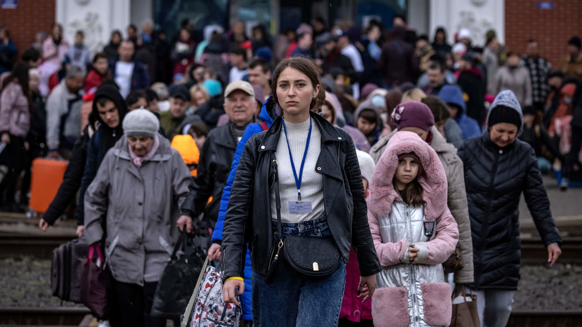Families arrive at the main train station as they flee the eastern city of Kramatorsk, in the Donbas region on April 3, 2022.