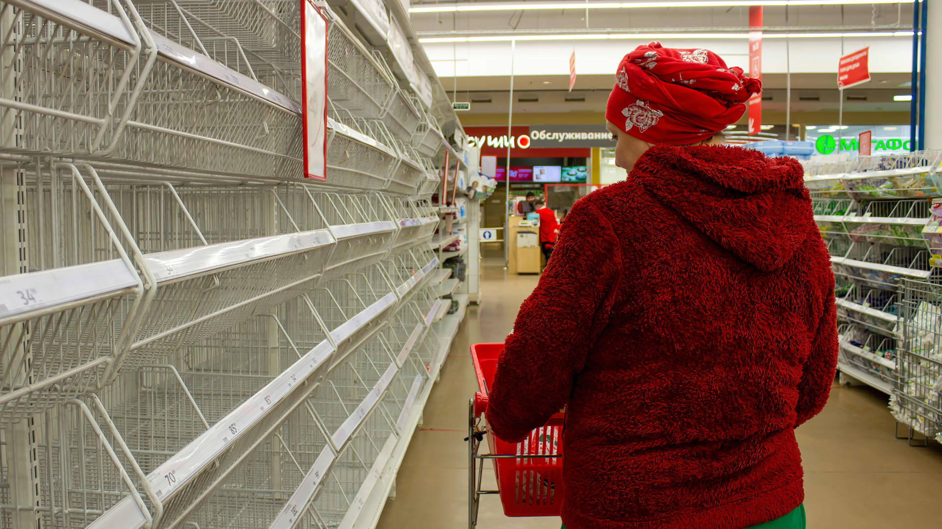 A woman looks at empty shelves in a supermarket in Moscow. There has been shortages of women's sanitary pads, diapers, and sugar after many foreign brands announced they were suspending their operations in Russia in light if the country's military operation in Ukraine.